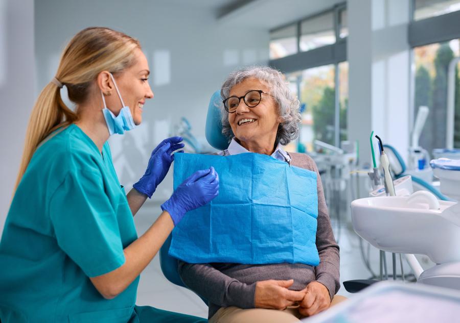 woman smile at dental technician in bright room