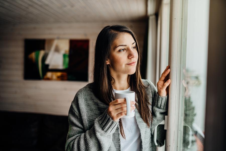 woman looking out window