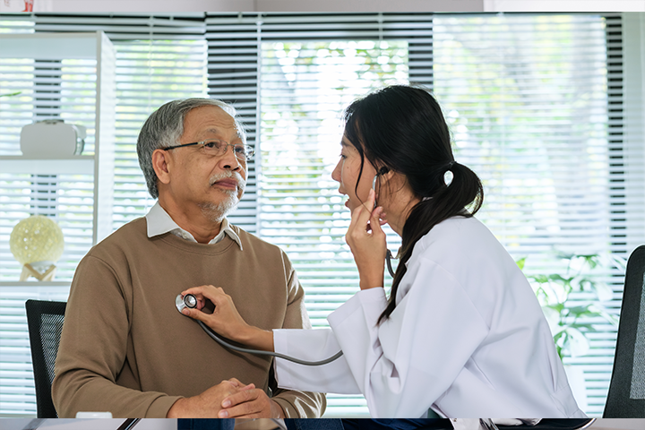 doctor checking man's heart