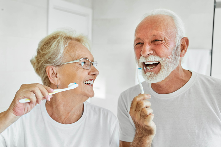 senior adults brushing teeth