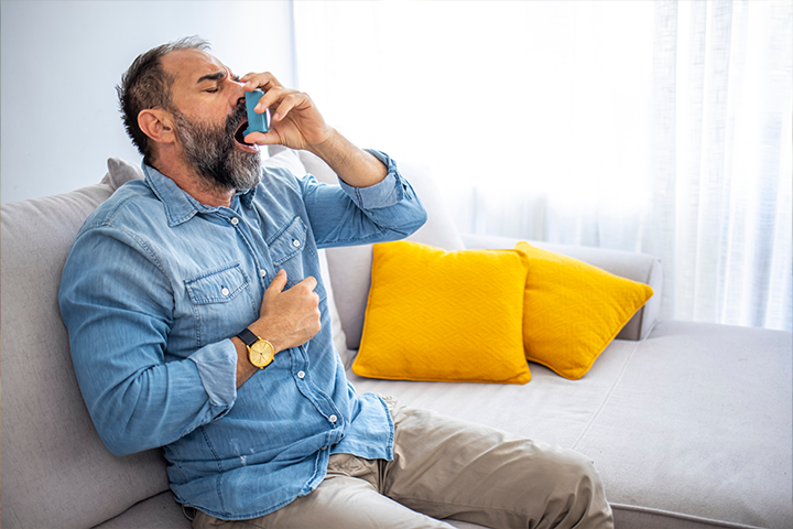 man inhaling medicine