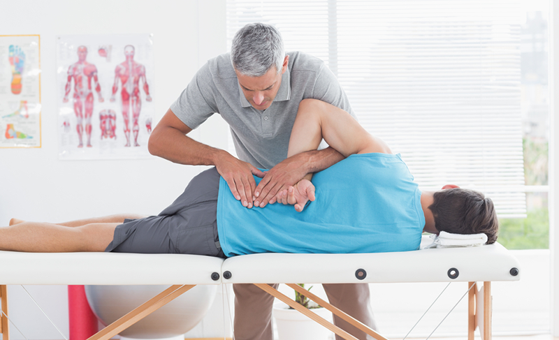 man receives back care from practitioner