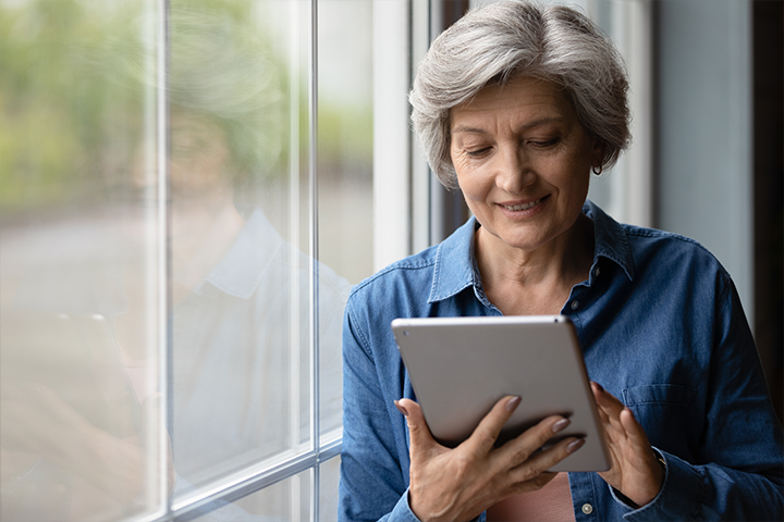 older woman looks at tablet