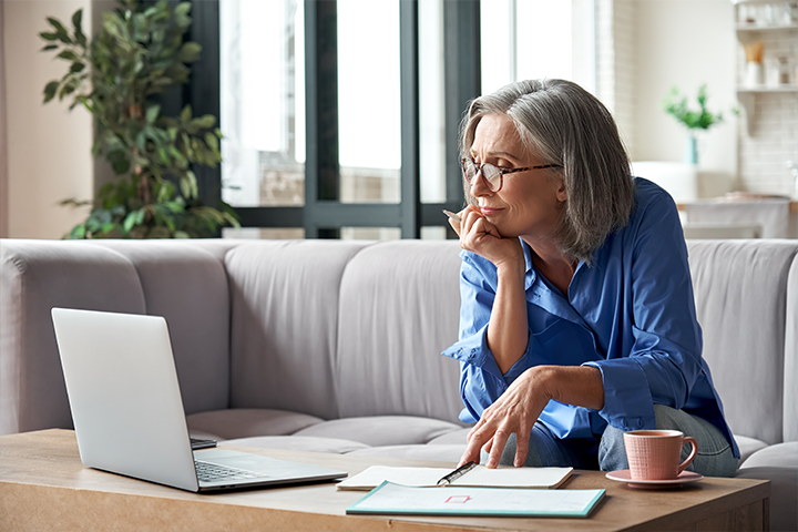 woman looks at computer screen