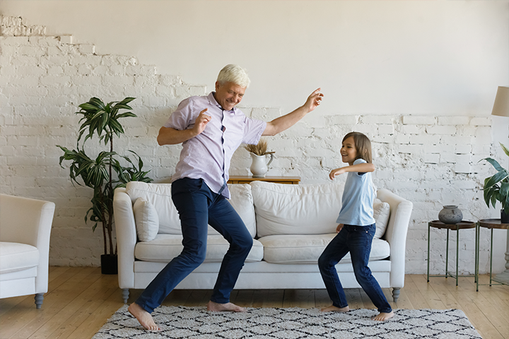 grandfather dancing with grandchild