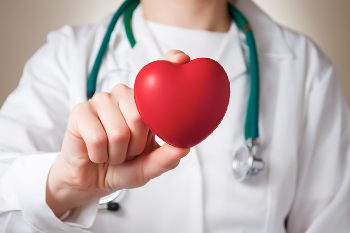 doctor holding heart figurine