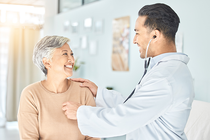 doctor checks woman’s heart