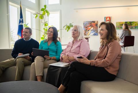 four retirees listen to a presentation
