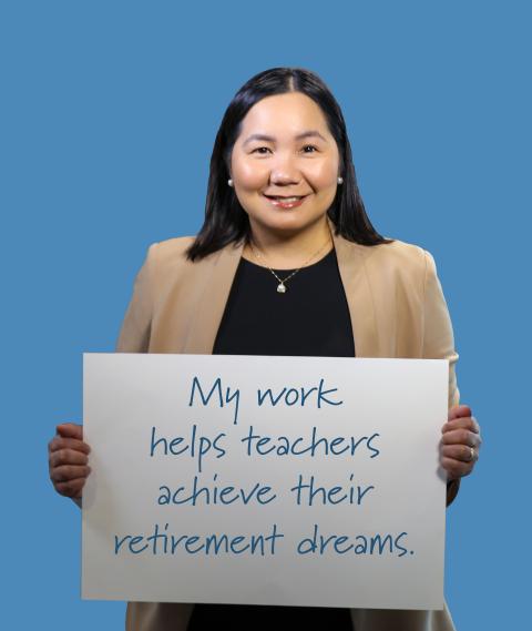 Woman holding sign "My work helps teachers achieve their retirement dreams."