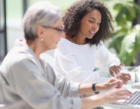 woman meets with retirement counselor in bright office